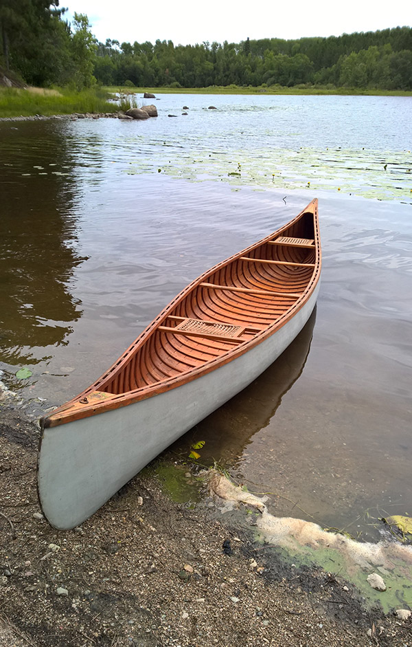 canoe on the shoreline of a lake 